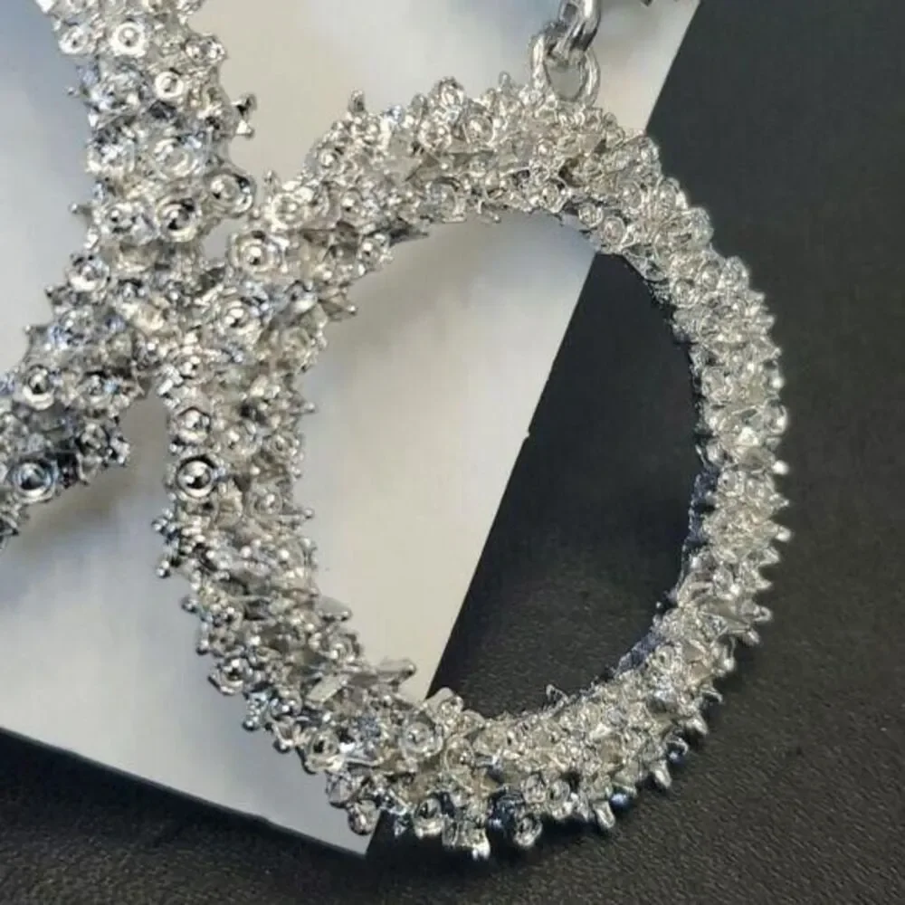 Silver tone circular themed statement earrings texture chunky